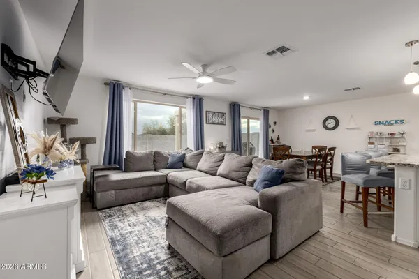 a living room with furniture and wooden floor