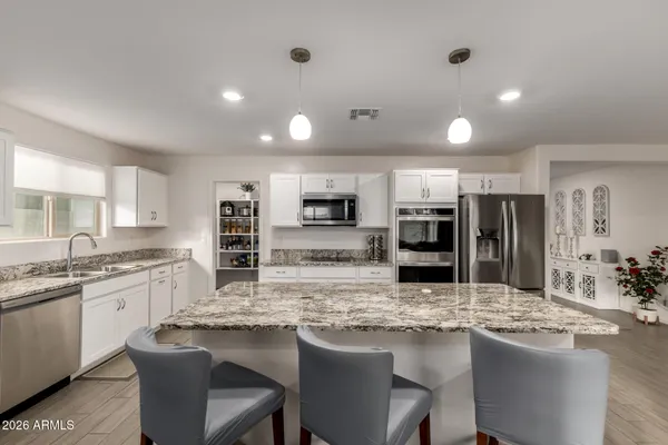 a kitchen with stainless steel appliances granite countertop a sink and stove