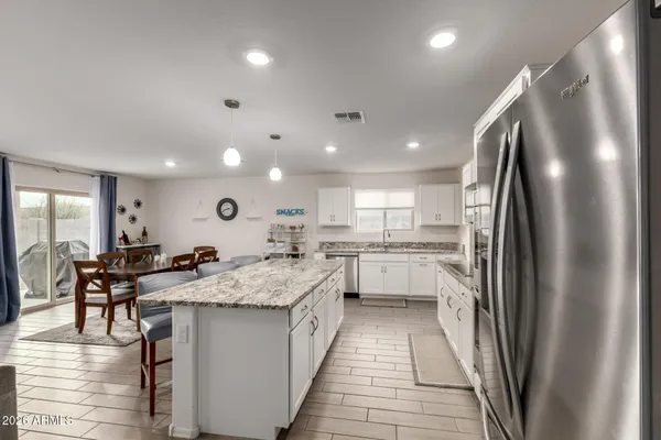 a kitchen with counter top space a sink appliances and cabinets