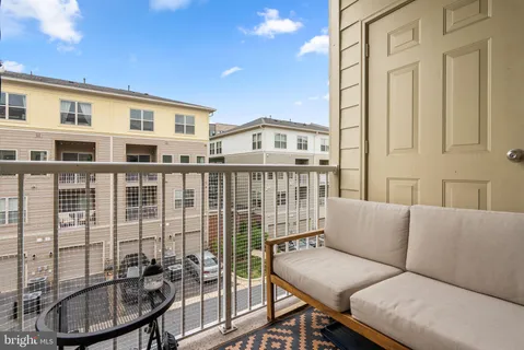 a balcony with table and chairs