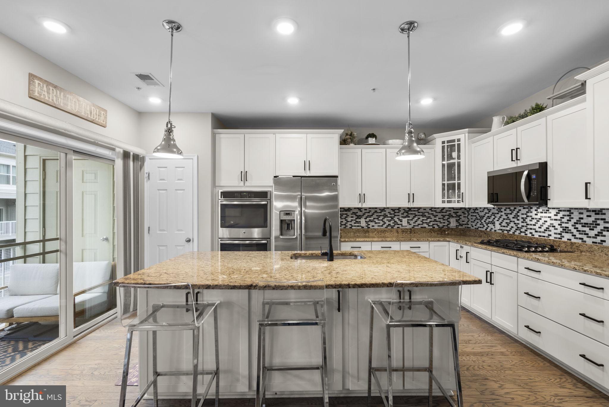 121 Copley Circle, Unit 34B Gaithersburg, MD 20878 - Photo 2 of 43 a large kitchen with granite countertop lots of counter space and stainless steel appliances