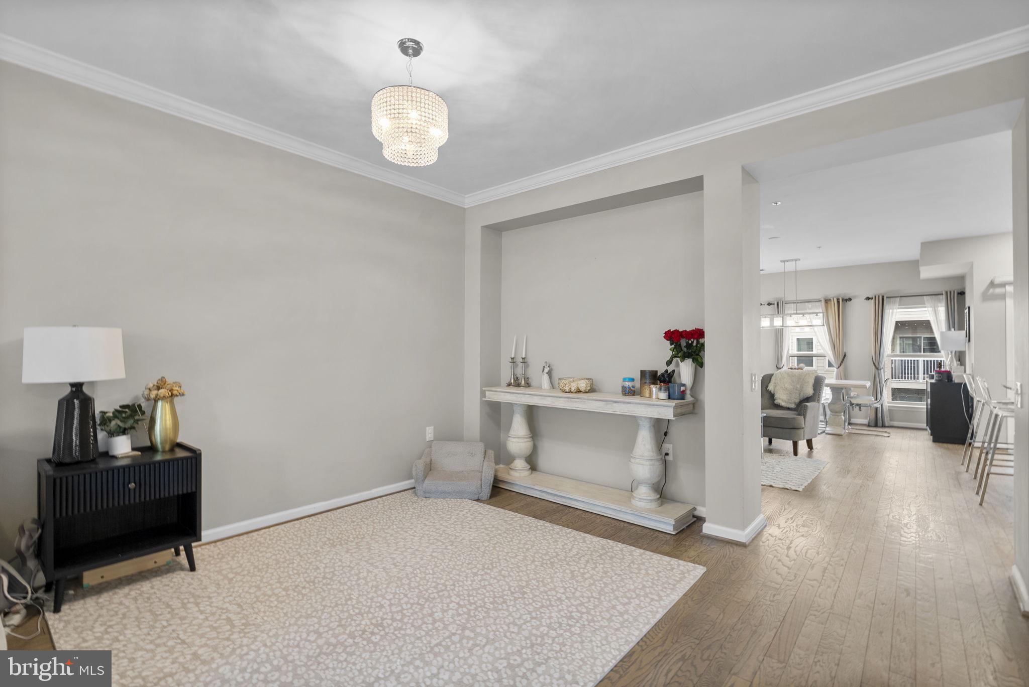 121 Copley Circle, Unit 34B Gaithersburg, MD 20878 - Photo 22 of 43 a living room with furniture and wooden floor