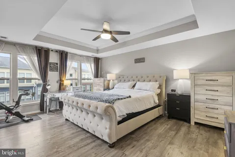 a large bedroom with a bed and large windows