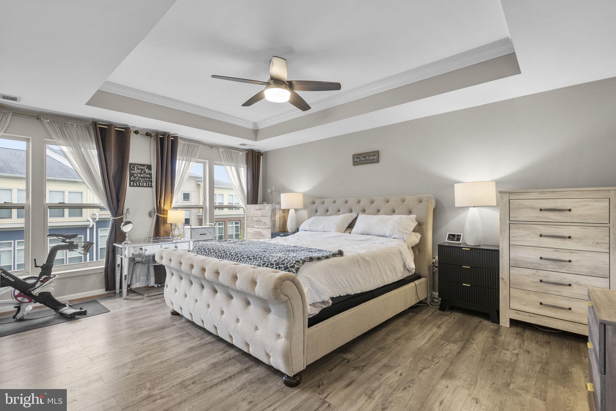 121 Copley Circle, Unit 34B Gaithersburg, MD 20878 - Photo 24 of 43 a large bedroom with a bed and large windows