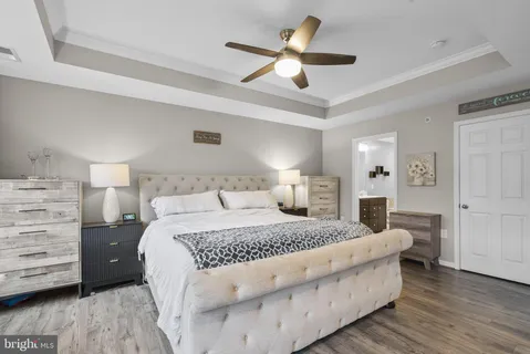 a bedroom with a large bed and a chandelier