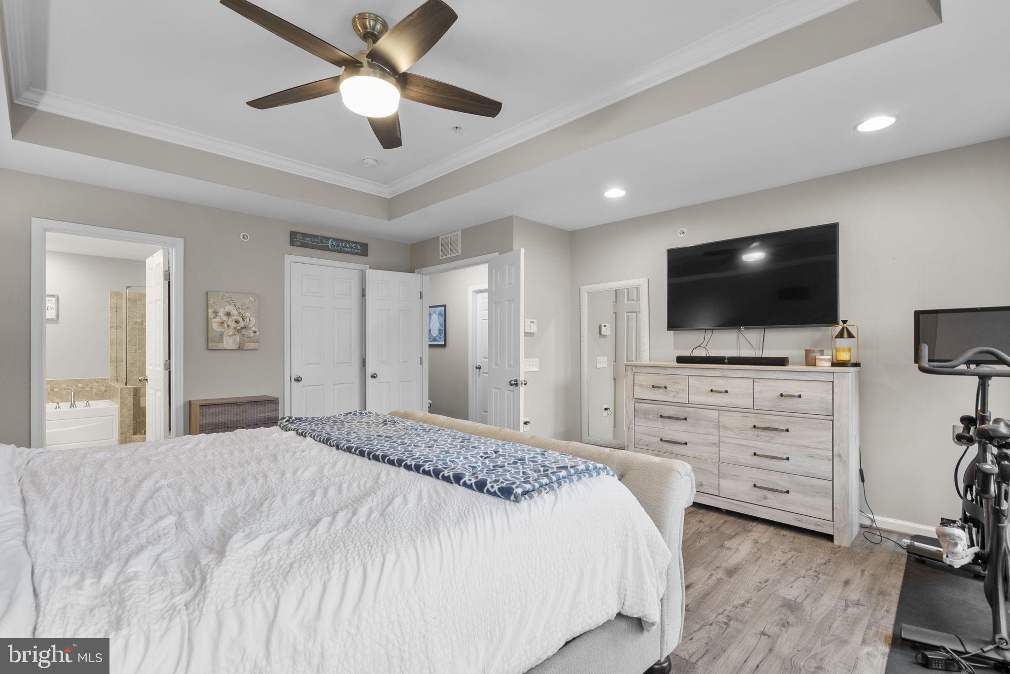 121 Copley Circle, Unit 34B Gaithersburg, MD 20878 - Photo 26 of 43 a bedroom with a bed and a flat screen tv