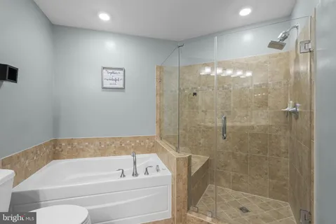 a bathroom with a bathtub and a shower