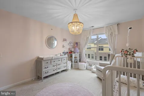 a bedroom with furniture and a large window
