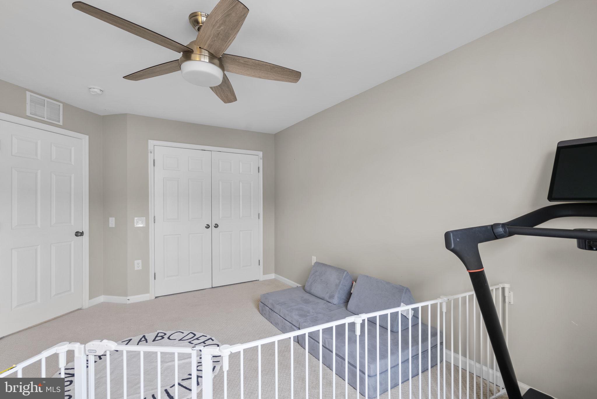 121 Copley Circle, Unit 34B Gaithersburg, MD 20878 - Photo 35 of 43 a view of a hallway to a bedroom with wooden floor and a ceiling fan