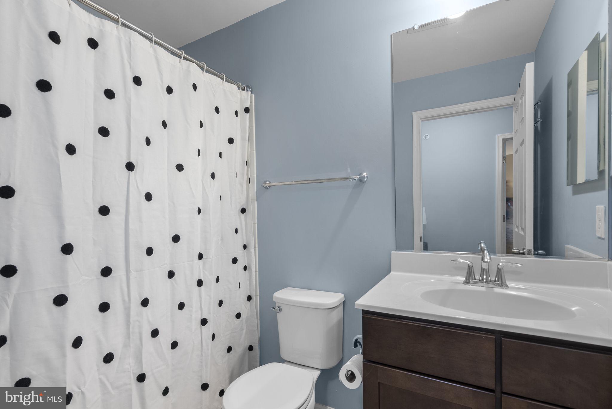 121 Copley Circle, Unit 34B Gaithersburg, MD 20878 - Photo 36 of 43 a bathroom with a sink a toilet and a mirror