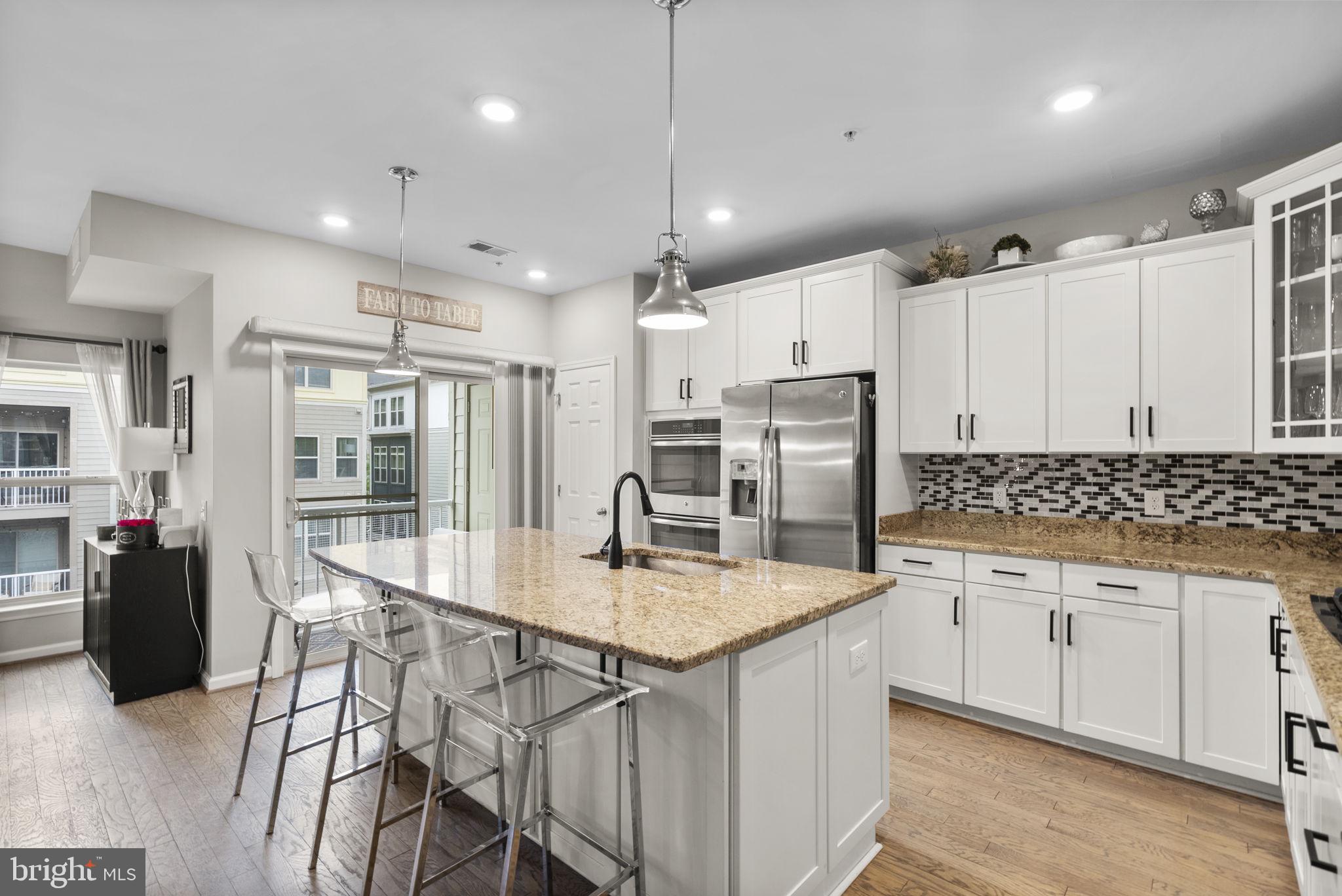 121 Copley Circle, Unit 34B Gaithersburg, MD 20878 - Photo 4 of 43 a kitchen with stainless steel appliances granite countertop a sink refrigerator and cabinets