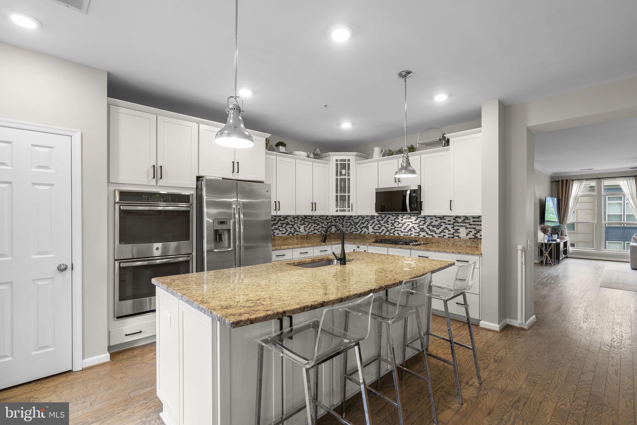 121 Copley Circle, Unit 34B Gaithersburg, MD 20878 - Photo 6 of 43 a kitchen with a table and chairs in it
