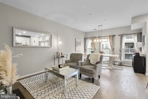 a living room with furniture and wooden floor
