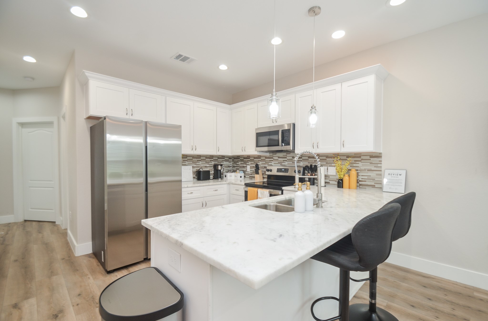 4511 Reed Road Houston, TX 77051 - Photo 14 of 39 a kitchen with white cabinets and stainless steel appliances