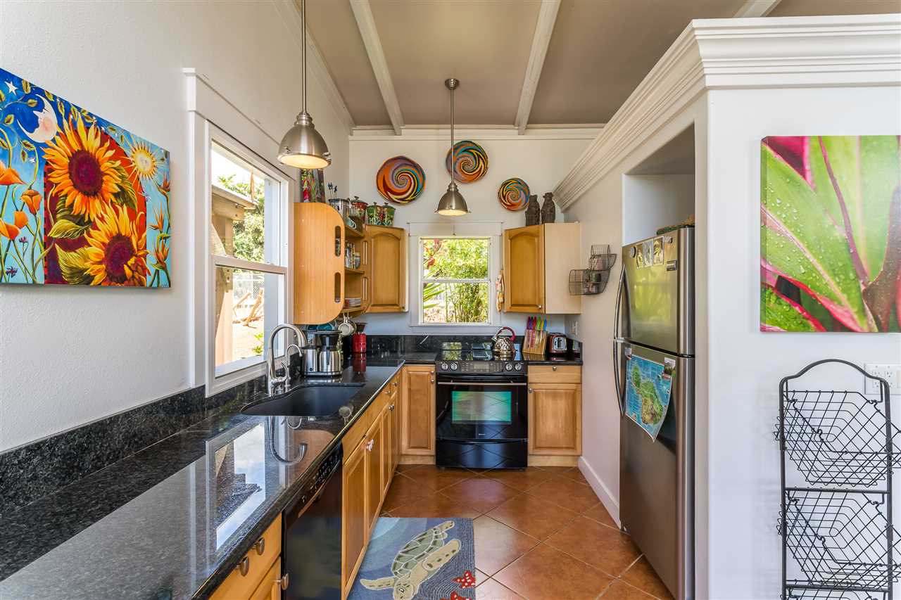 2425 Lilikoi Road Haiku, HI 96708 - Photo 22 of 30 a kitchen with stainless steel appliances granite countertop a refrigerator and a stove