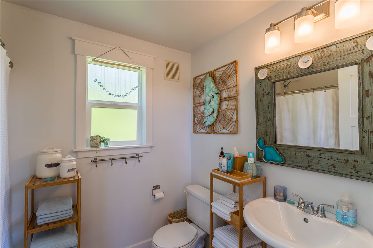 2425 Lilikoi Road Haiku, HI 96708 - Photo 24 of 30 a bathroom with a toilet sink and mirror