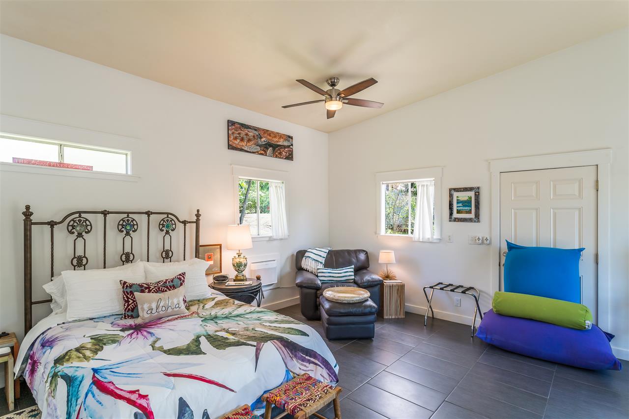 2425 Lilikoi Road Haiku, HI 96708 - Photo 25 of 30 a bedroom with bed and a couch