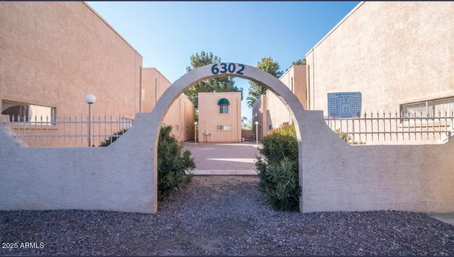 a view of a big building with large windows and a yard