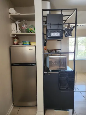 a kitchen with appliances and a refrigerator