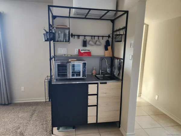 a kitchen with a refrigerator and cabinets