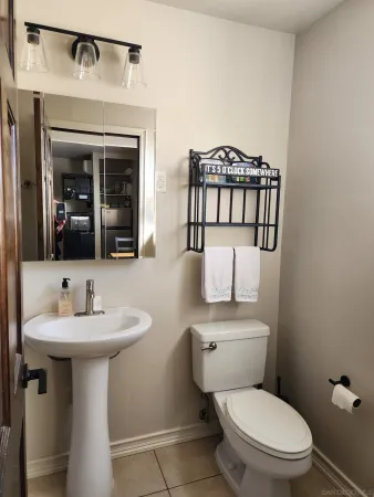 a bathroom with a toilet sink and mirror