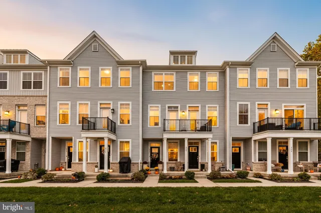 a living room with granite countertop furniture and a wooden floor
