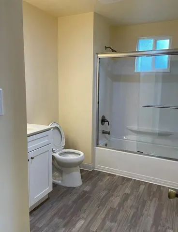 a view of a street with a cars parked on the road