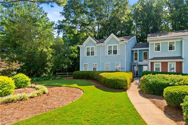 a front view of a house with garden