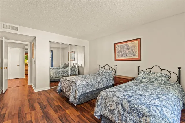 a bedroom with two beds and painting on the wall