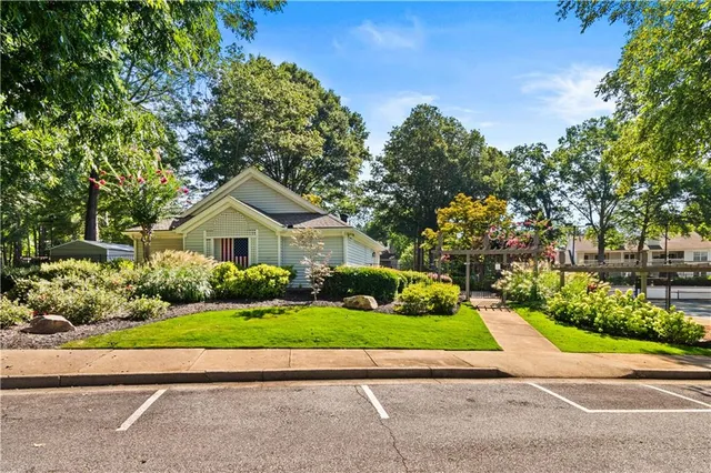 a view of a house with backyard sitting area and swimming pool