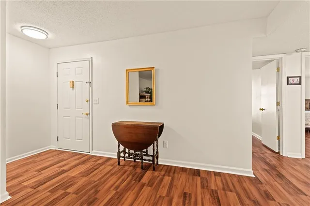 a view of room with wooden floor and lounge chair