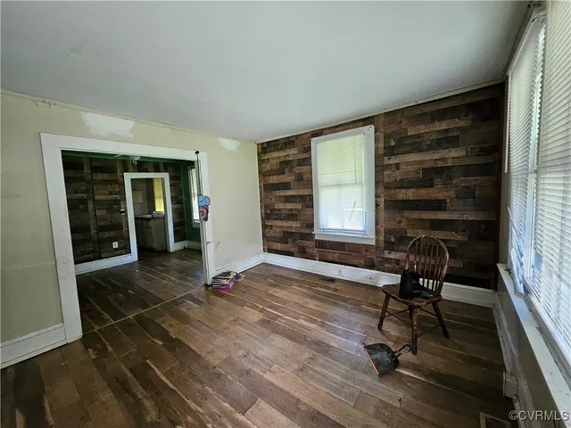 a view of a livingroom with chair and a window
