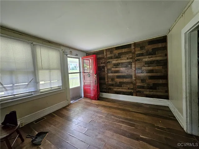 a view of wooden floor and windows in a room