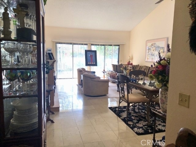 200 East Racquet Club Road, Unit 19 Palm Springs, CA 92262 - Photo 5 of 21 a living room filled with furniture a couch and a window