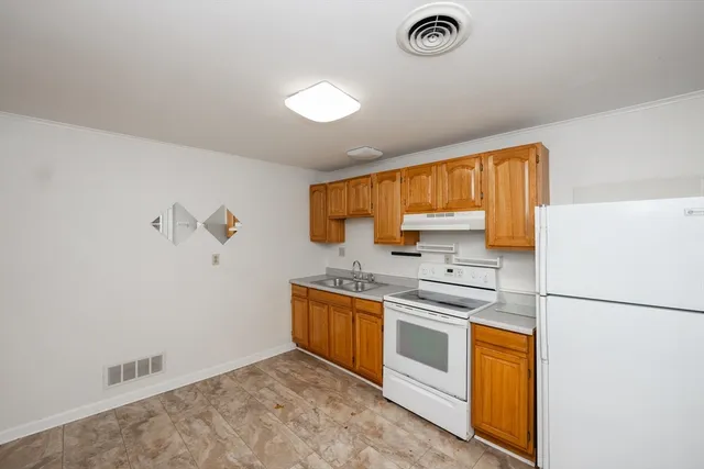 a kitchen with stainless steel appliances a stove a sink and a refrigerator