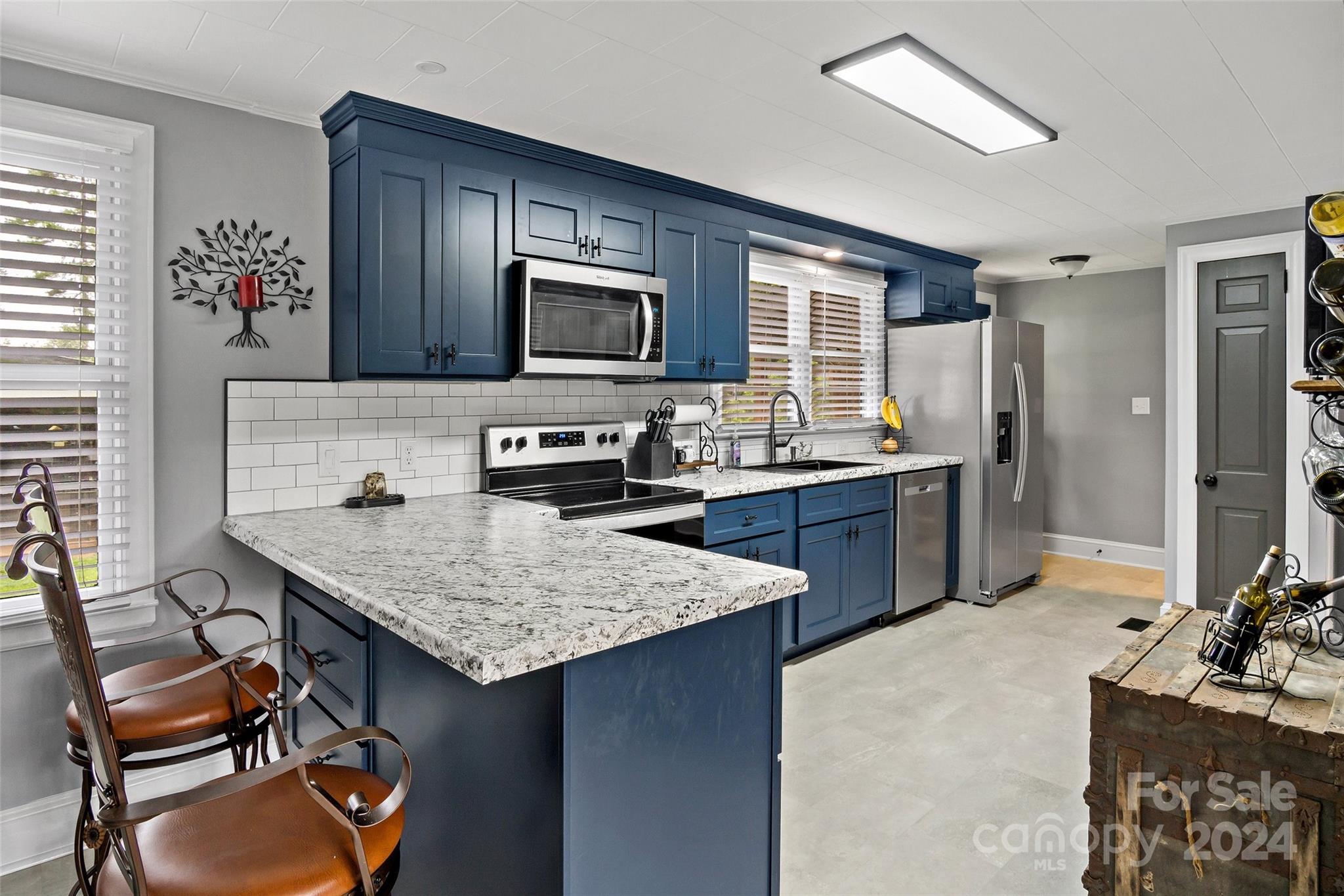 1798 Hopewell Road Morganton, NC 28655 - Photo 13 of 45 a kitchen with stainless steel appliances granite countertop a sink dishwasher stove refrigerator and microwave
