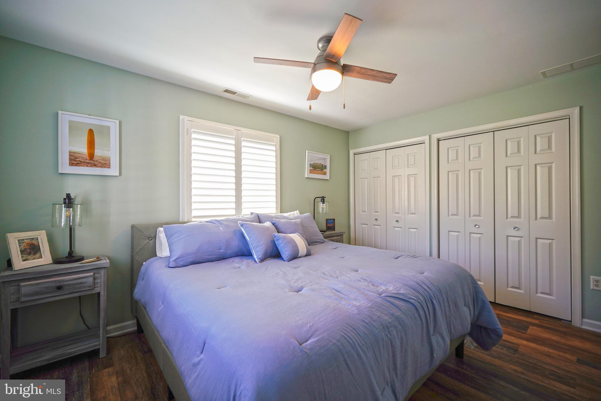 112 Lakeside Drive Lewes, DE 19958 - Photo 13 of 31 a bedroom with a large bed and a chandelier