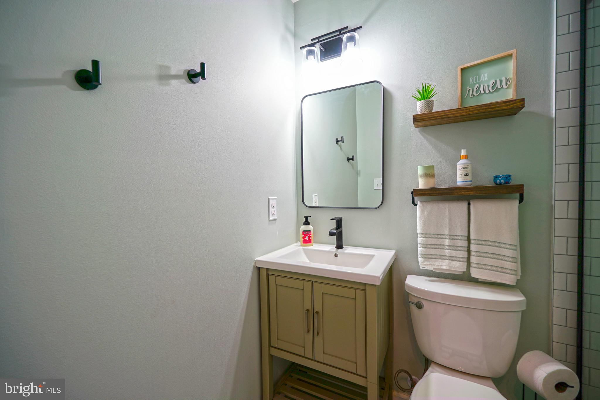 112 Lakeside Drive Lewes, DE 19958 - Photo 15 of 31 a bathroom with a toilet sink vanity tub and mirror
