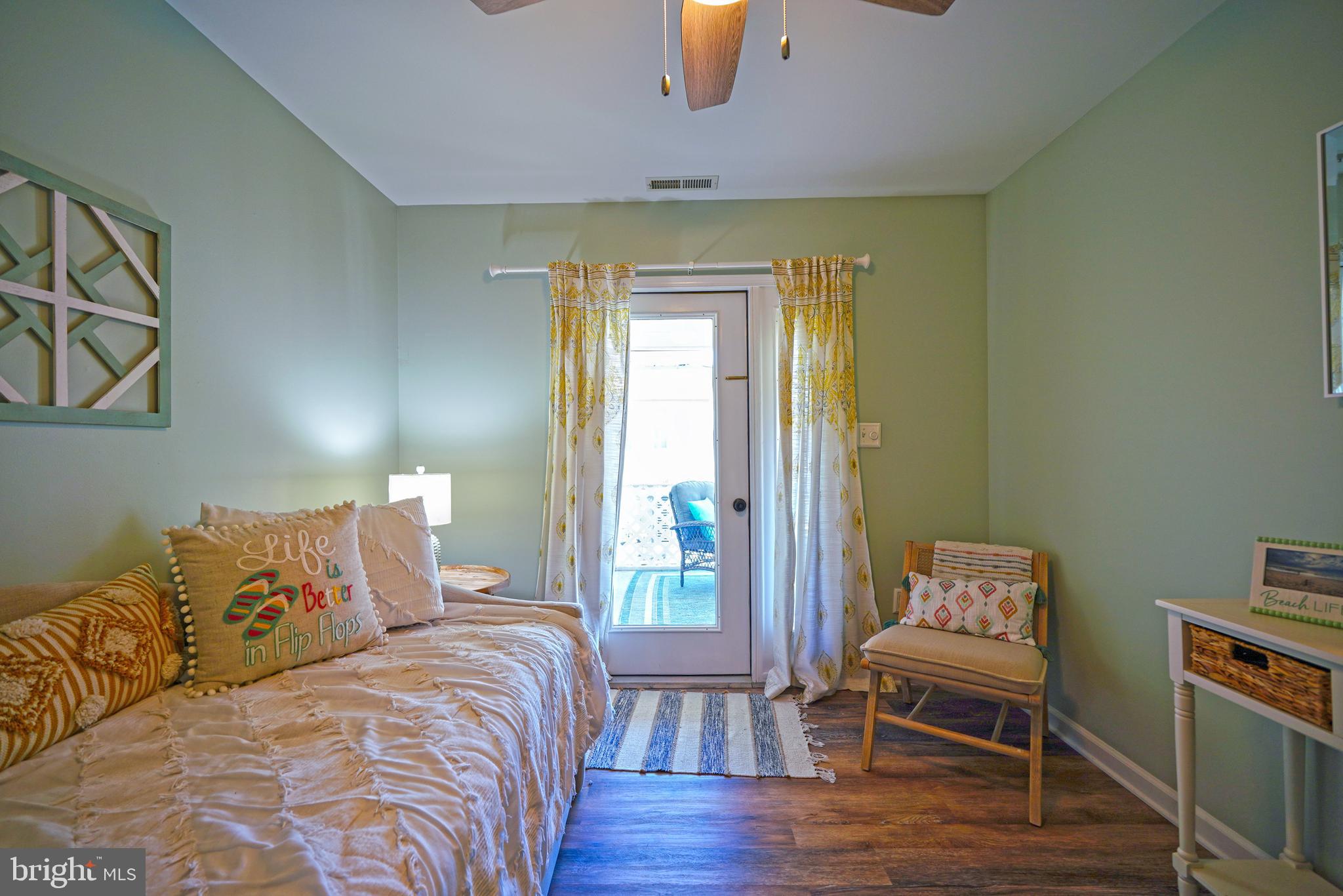 112 Lakeside Drive Lewes, DE 19958 - Photo 17 of 31 a bedroom with a bed and wooden floor