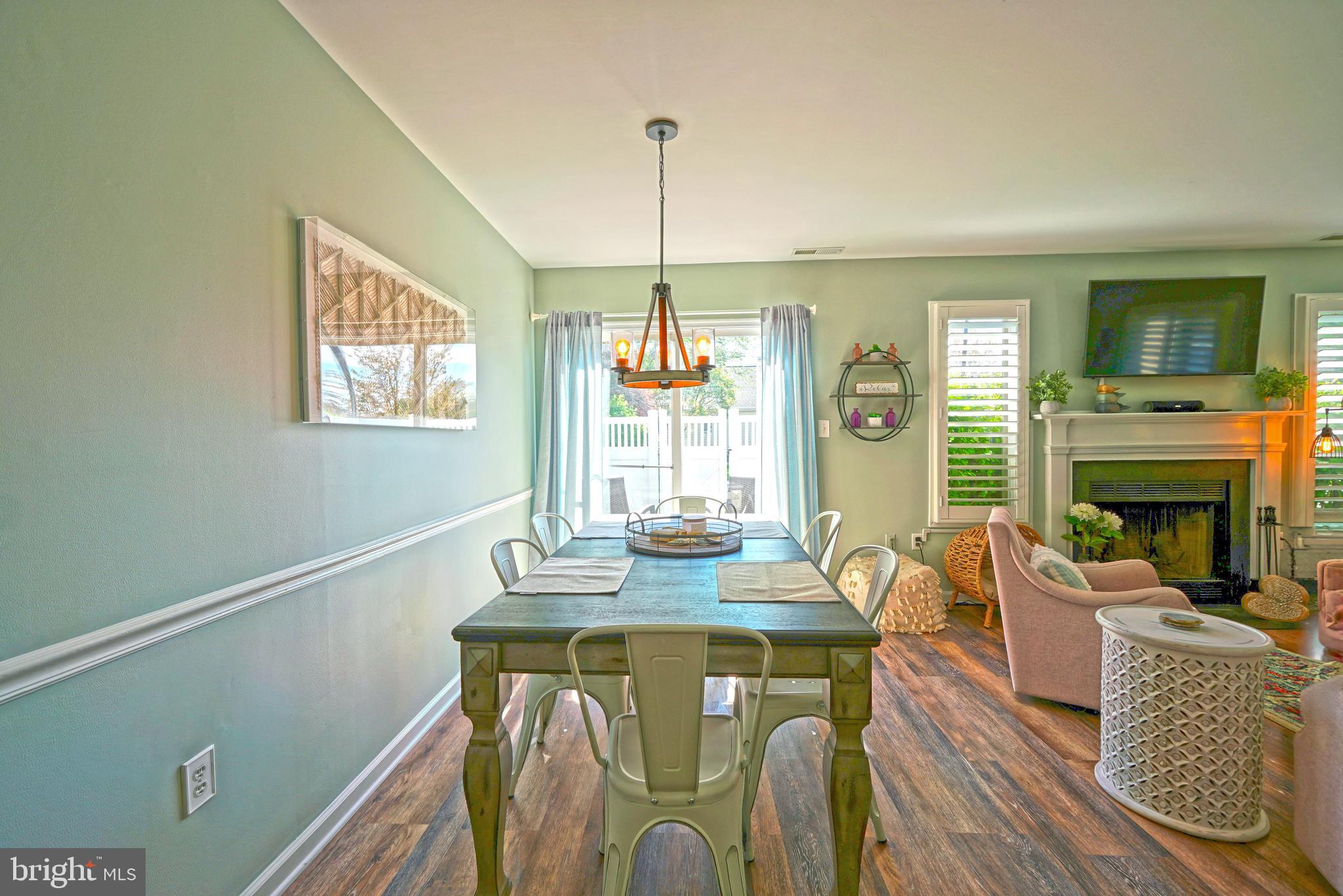 112 Lakeside Drive Lewes, DE 19958 - Photo 9 of 31 a dining room with furniture a livingroom and chandelier