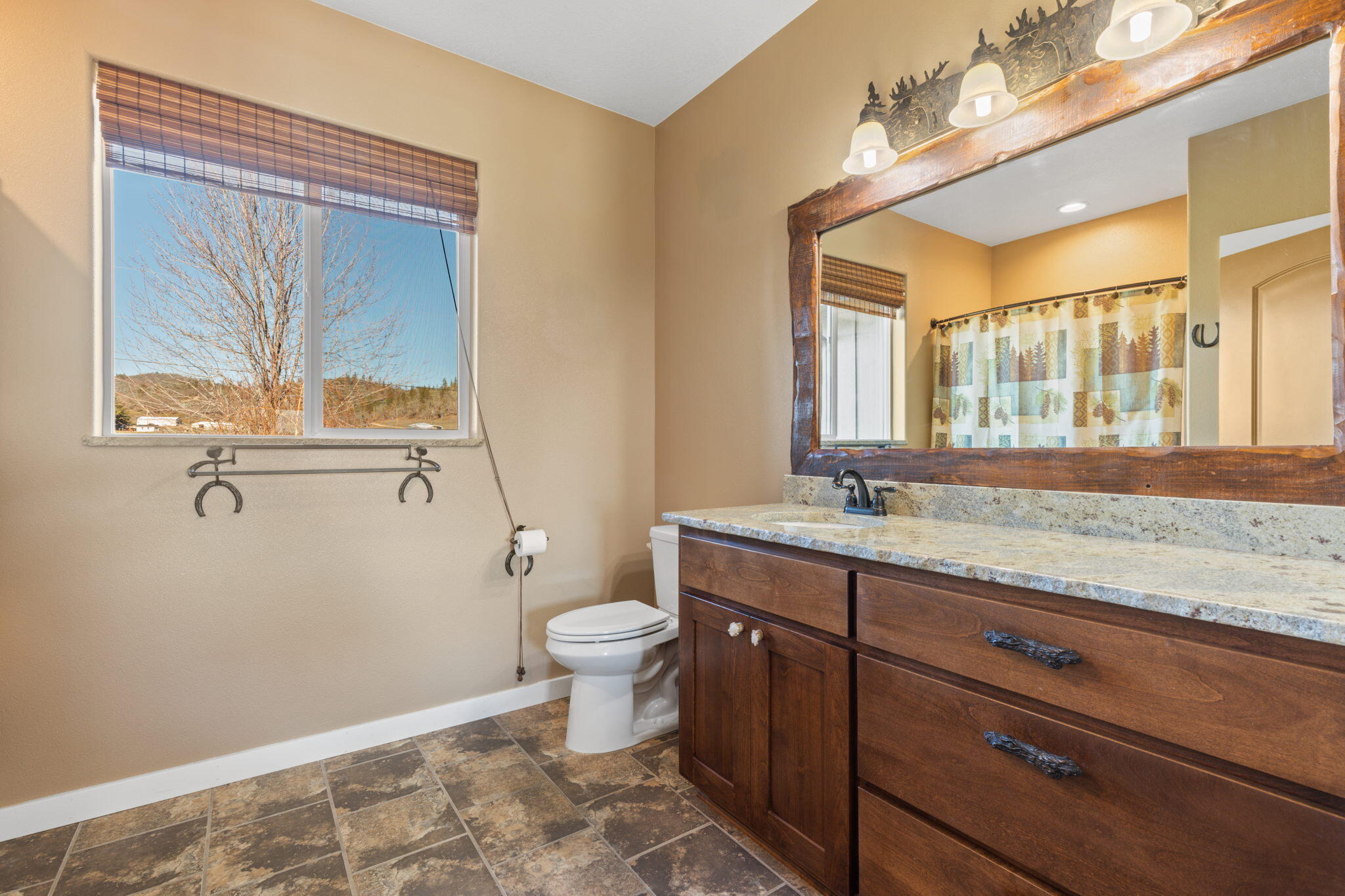 3923 Beagle Road White City, OR 97503 - Photo 23 of 31 a bathroom with a granite countertop sink mirror vanity and toilet