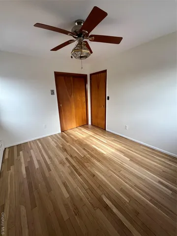 a view of a room with a ceiling fan