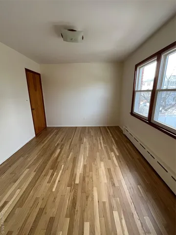 a view of a room with wooden floor and windows