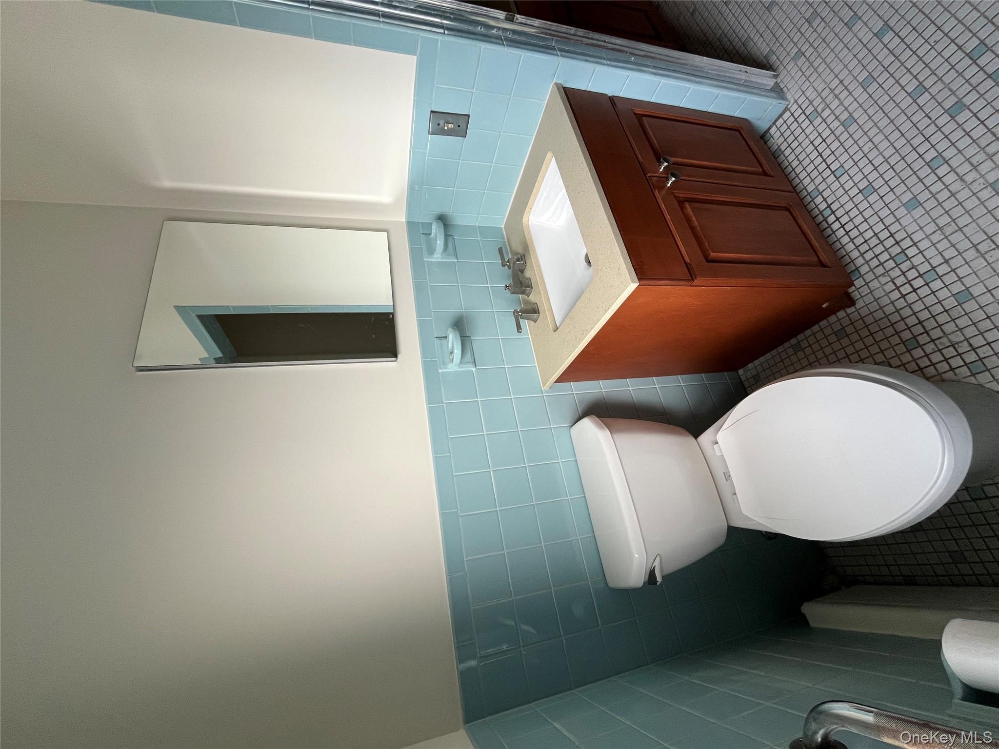 72 Bowman Avenue Rye Brook, NY 10573 - Photo 14 of 18 Hall bath with bathtub, vanity & toilet.