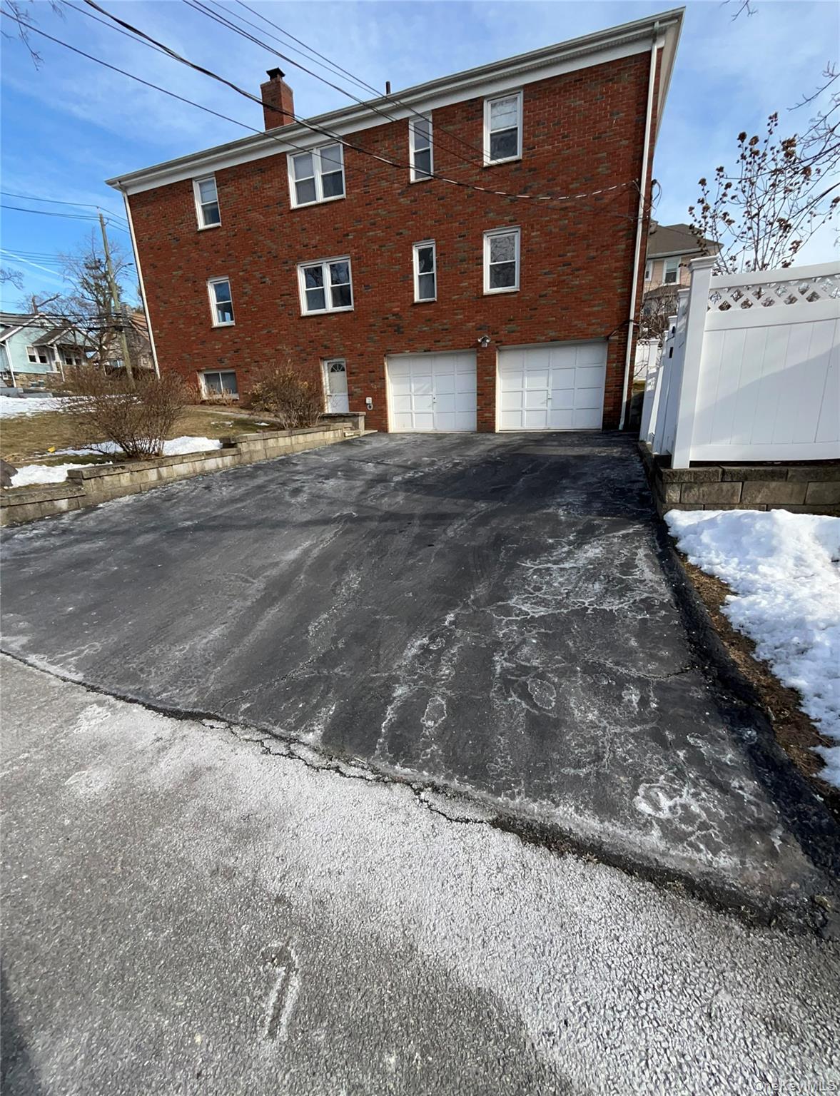 72 Bowman Avenue Rye Brook, NY 10573 - Photo 18 of 18 Side view of house showing driveway. Rent includes parking for one car in driveway.