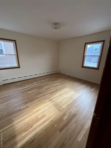 a view of an empty room and wooden floor