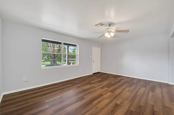 wooden floor in an empty room with a window