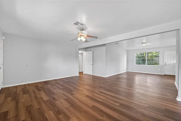 wooden floor in an empty room with a window