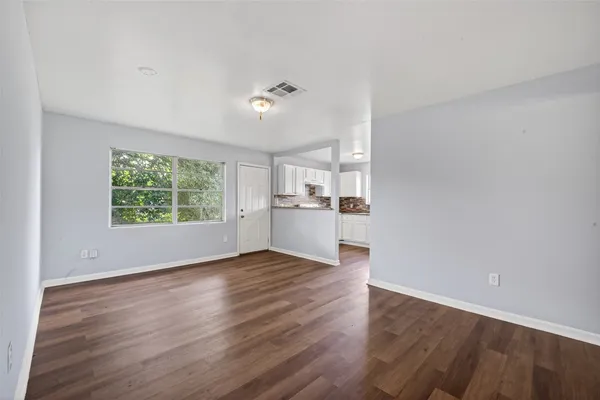 wooden floor in an empty room with a window
