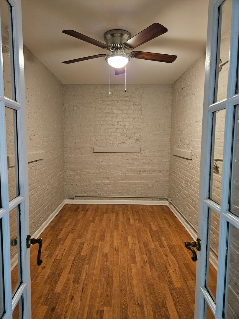 4012 North Sheridan Road, Unit GN Chicago, IL 60613 - Photo 11 of 13 a view of a room with wooden floor and white walls